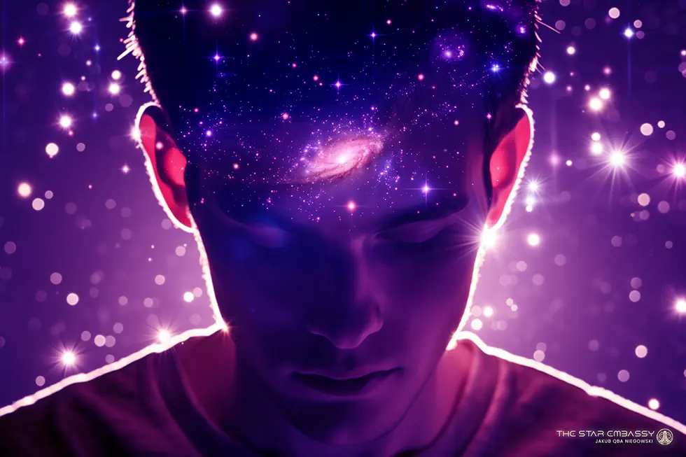 A person meditating peacefully with headphones in soft, warm light